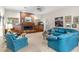 Bright living room with a brick fireplace and comfortable seating perfect for relaxation and entertainment at 1671 South Dr, Sarasota, FL 34239