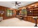 Spacious office with built-in bookshelves, wood paneling, and a large window view at 1671 South Dr, Sarasota, FL 34239