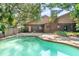 Backyard pool with brick exterior and tropical foliage creates a relaxing backyard retreat at 1671 South Dr, Sarasota, FL 34239