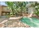 Backyard pool surrounded by tropical foliage and mature shade trees creates a private oasis at 1671 South Dr, Sarasota, FL 34239