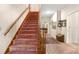 Carpeted staircase with wooden handrails leading to the upper level of the home at 1671 South Dr, Sarasota, FL 34239