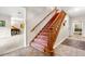 Carpeted staircase with wooden handrails leading to the upper level of the home at 1671 South Dr, Sarasota, FL 34239