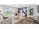 Bright living room featuring stylish furniture, a flat-screen TV, and hardwood floors at 1754 Cobb Trl, Parrish, FL 34219