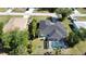This home boasts a screened pool, mature trees and landscaping, and a well-maintained lawn at 21498 Beaverton Ave, Port Charlotte, FL 33952