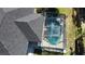 Aerial view showcasing a screened pool, well-maintained roof, and easy access to the patio at 21498 Beaverton Ave, Port Charlotte, FL 33952
