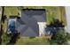 Aerial shot of a house with a screened-in pool, dark roof, and well-maintained surrounding landscape at 21498 Beaverton Ave, Port Charlotte, FL 33952