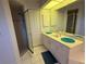 Bathroom with dual sinks, vanity, shower with sliding glass door, and ample storage space at 21498 Beaverton Ave, Port Charlotte, FL 33952