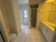 Well-lit bathroom features a walk-in shower, white tiled floors, and large closet space at 21498 Beaverton Ave, Port Charlotte, FL 33952
