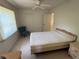 Bright bedroom features a ceiling fan, tiled flooring, and closet for ample storage at 21498 Beaverton Ave, Port Charlotte, FL 33952