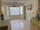 Bright breakfast nook with block windows, tile floor, and decorative hanging light at 21498 Beaverton Ave, Port Charlotte, FL 33952