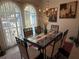 Elegant dining room with chandelier, glass table, and bright windows creating a sophisticated atmosphere at 21498 Beaverton Ave, Port Charlotte, FL 33952