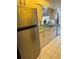Kitchen featuring stainless steel refrigerator and sink with open view to dining and living areas at 21498 Beaverton Ave, Port Charlotte, FL 33952