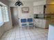 Bright kitchen with tiled floor, blue chairs, and ample cabinet space, perfect for casual dining at 21498 Beaverton Ave, Port Charlotte, FL 33952