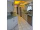 Well-lit kitchen featuring ample counter space, stainless steel appliances, and tiled flooring at 21498 Beaverton Ave, Port Charlotte, FL 33952