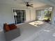 Covered lanai with comfortable seating and view of the pool and backyard at 21498 Beaverton Ave, Port Charlotte, FL 33952