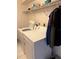 Functional laundry room with washer, dryer, and shelving for storage, designed for efficiency at 21498 Beaverton Ave, Port Charlotte, FL 33952
