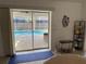 View from living room through sliding glass doors to lanai and pool at 21498 Beaverton Ave, Port Charlotte, FL 33952