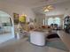 Spacious living room with tile floors, vaulted ceilings, and open floor plan flowing into dining area at 21498 Beaverton Ave, Port Charlotte, FL 33952