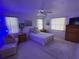 Relaxing bedroom with neutral colors, tile floors, ceiling fan, and bright windows at 21498 Beaverton Ave, Port Charlotte, FL 33952