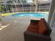 Relaxing screened pool with an inflatable, lounge area, and covered patio with outdoor seating at 21498 Beaverton Ave, Port Charlotte, FL 33952