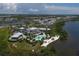 Stunning aerial view of the waterfront community featuring a beautiful pool, beach area, and lush landscaping at 262 Sapphire Lake Dr # 202, Bradenton, FL 34209