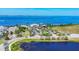 Aerial view of community waterfront amenities, manicured landscaping, and clubhouse with ample parking at 262 Sapphire Lake Dr # 202, Bradenton, FL 34209