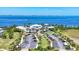 Aerial view showcasing the community's beautiful landscaping, waterfront location, clubhouse, and parking at 262 Sapphire Lake Dr # 202, Bradenton, FL 34209