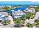 Aerial view showcasing a beautiful blue home, lush landscaping, lake access and neighborhood at 262 Sapphire Lake Dr # 202, Bradenton, FL 34209
