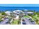 Aerial view of the community's clubhouse, parking area, landscaping, and waterfront location at 262 Sapphire Lake Dr # 202, Bradenton, FL 34209
