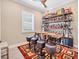 Home bar with a bicycle-themed bar, shelving with liquor bottles, and three bar stools at 262 Sapphire Lake Dr # 202, Bradenton, FL 34209
