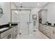Beautiful ensuite bathroom with a glass enclosed shower and dual vanities, plus updated fixtures at 262 Sapphire Lake Dr # 202, Bradenton, FL 34209