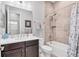 Neutral tiled bathroom featuring a modern vanity with dark cabinets and a shower-over-tub combination at 262 Sapphire Lake Dr # 202, Bradenton, FL 34209