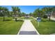 Lush, green community park with walking path, water feature, and mature trees at 262 Sapphire Lake Dr # 202, Bradenton, FL 34209