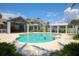 Resort-style community pool with lounge chairs, shaded areas, and lush tropical landscaping at 262 Sapphire Lake Dr # 202, Bradenton, FL 34209