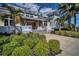 Welcoming clubhouse entrance with vibrant greenery and a modern design, perfect for social gatherings and events at 262 Sapphire Lake Dr # 202, Bradenton, FL 34209