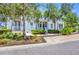 Inviting two-story home with white trim, a charming front porch, and lush green landscaping at 262 Sapphire Lake Dr # 202, Bradenton, FL 34209