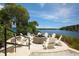 Community fire pit area with Adirondack chairs and serene water views at 262 Sapphire Lake Dr # 202, Bradenton, FL 34209