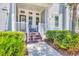 Inviting front porch with neutral decor, featuring outdoor seating and manicured greenery at 262 Sapphire Lake Dr # 202, Bradenton, FL 34209