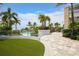 Beautifully landscaped grounds with paved walkways, lush lawn, and a glimpse of the inviting community pool at 262 Sapphire Lake Dr # 202, Bradenton, FL 34209