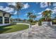 Lush, landscaped grounds with palm trees and stunning waterfront views create a serene outdoor space at 262 Sapphire Lake Dr # 202, Bradenton, FL 34209