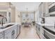 Open kitchen with gray cabinets, white countertops, stainless steel appliances, and breakfast nook at 262 Sapphire Lake Dr # 202, Bradenton, FL 34209