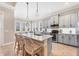 Modern kitchen featuring stainless steel appliances, an island with a sink, and barstool seating at 262 Sapphire Lake Dr # 202, Bradenton, FL 34209