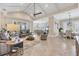 Open living and dining area featuring neutral tones and a vaulted ceiling with exposed beams at 262 Sapphire Lake Dr # 202, Bradenton, FL 34209