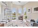 Bright living room with a spiral staircase, multiple windows, and water views at 262 Sapphire Lake Dr # 202, Bradenton, FL 34209
