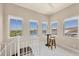 Bright living space featuring a spiral staircase, a high table with barstools, and lake views at 262 Sapphire Lake Dr # 202, Bradenton, FL 34209
