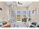 Sunlit living room with a spiral staircase, water views, and comfortable seating at 262 Sapphire Lake Dr # 202, Bradenton, FL 34209