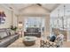 Open living area with a vaulted ceiling, tiled floors, and views to the outside at 262 Sapphire Lake Dr # 202, Bradenton, FL 34209