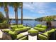 Waterfront patio featuring comfortable seating with lush green cushions overlooking the serene water at 262 Sapphire Lake Dr # 202, Bradenton, FL 34209