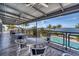 Inviting outdoor patio with dining tables, chairs, ceiling fans and amazing waterfront and pool views at 262 Sapphire Lake Dr # 202, Bradenton, FL 34209