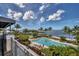 Stunning aerial view of the sparkling pool area surrounded by palm trees and picturesque waterfront scenery at 262 Sapphire Lake Dr # 202, Bradenton, FL 34209